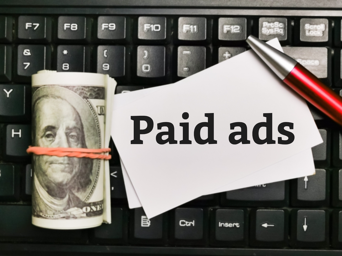 Paid search advertising. Money with computer