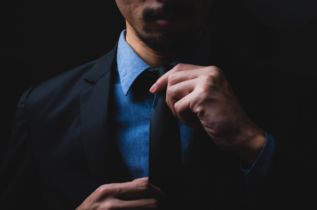 Online reputation. business man in black suit and adjusting his necktie